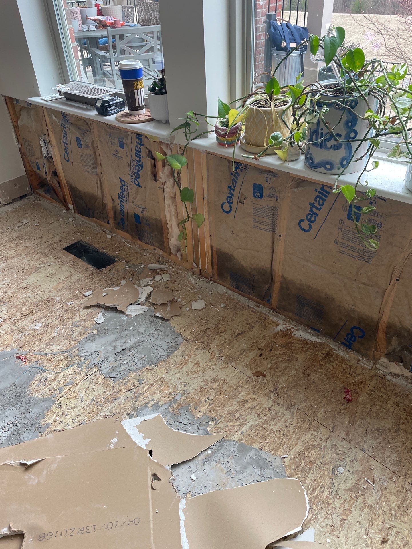 Damaged wall insulation and subfloor after storm damage in Lexington