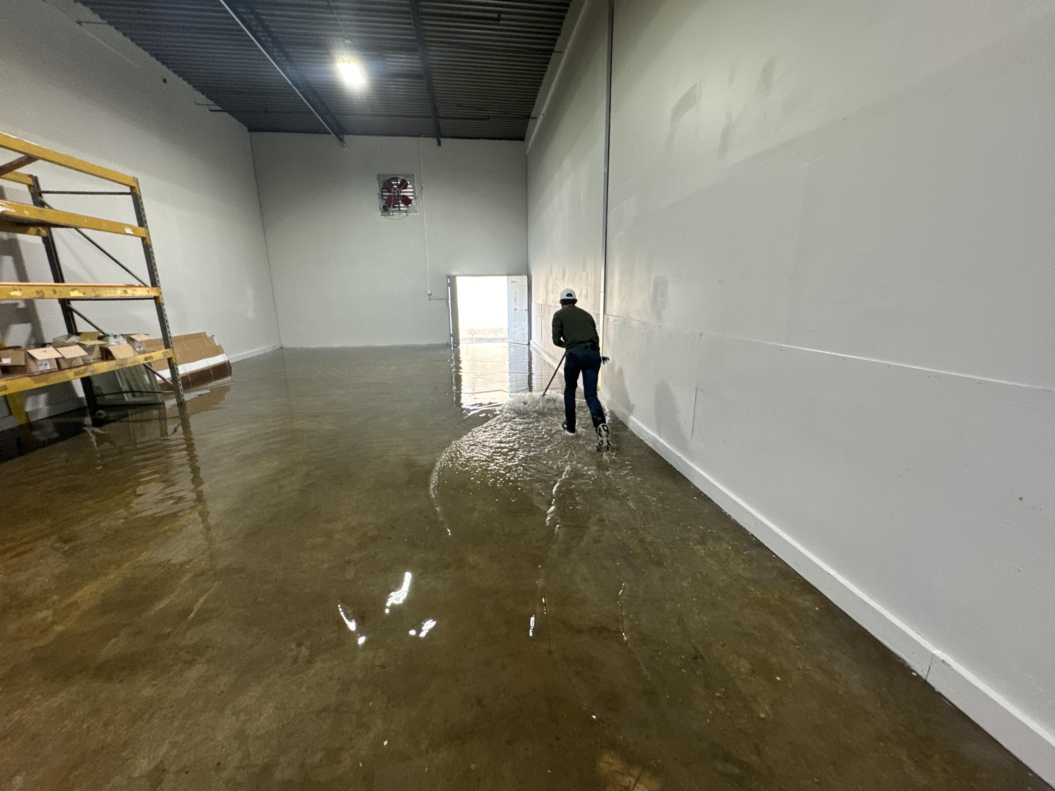 IRS crew member extracting standing water from a Lexington commercial building