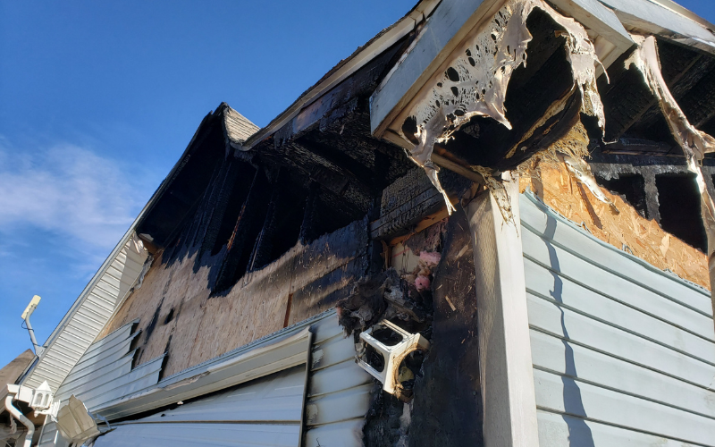 Exterior of a Lexington house with fire damage to roof and siding